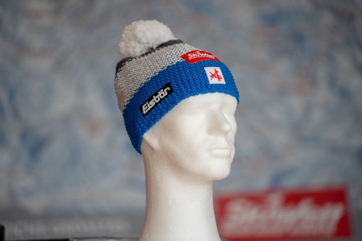 a white mannequin head with a red and white hat