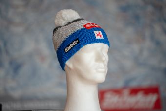 a white mannequin head with a red and white hat